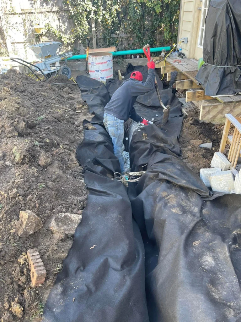 French drain and yard drainage solution for water pooling near a home